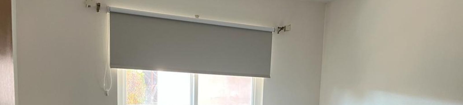 Sequence showing a bedroom window with roller shades partially closed highlighting the versatility and effectiveness of custom window shades for bedrooms.